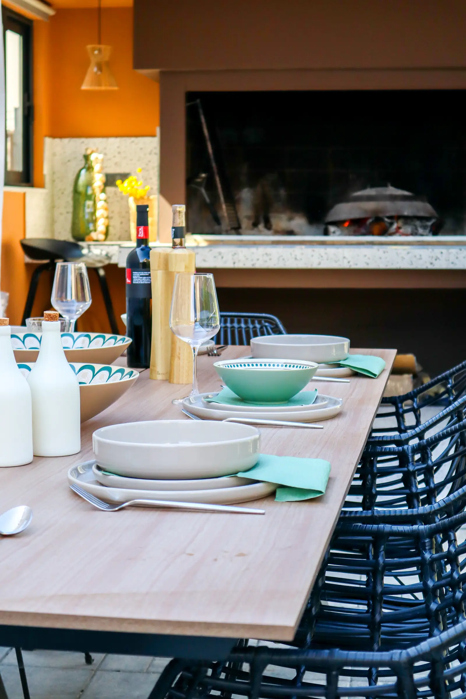 Summer kitchen and grill with the outdoor dining table in view